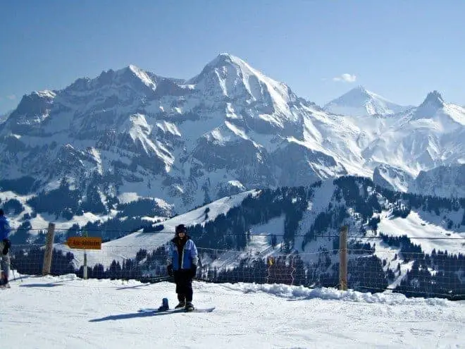 woman with snowboard in winter in Adelboden