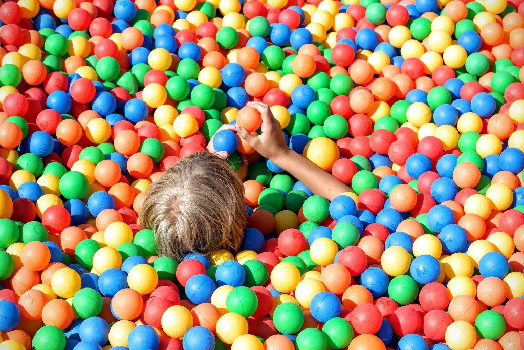 kid in bright color ball pit