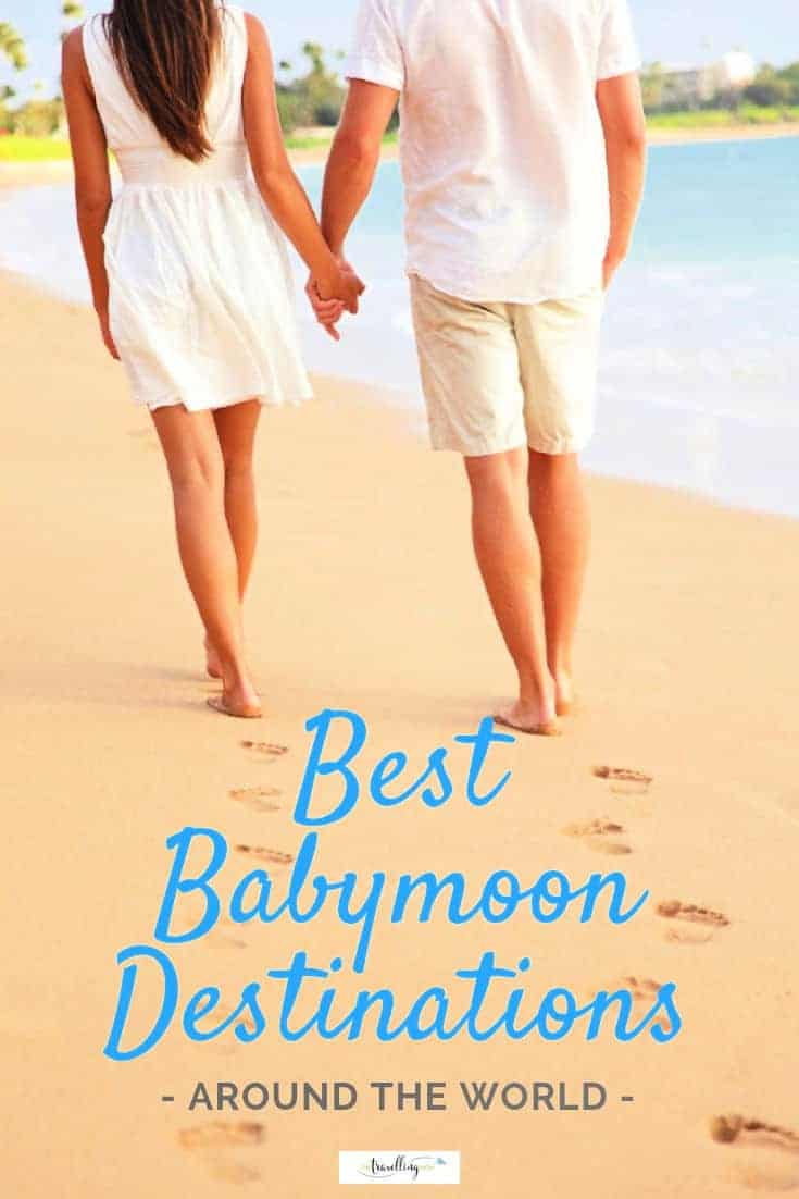 couple walking along beach while on best babymoon destination holiday