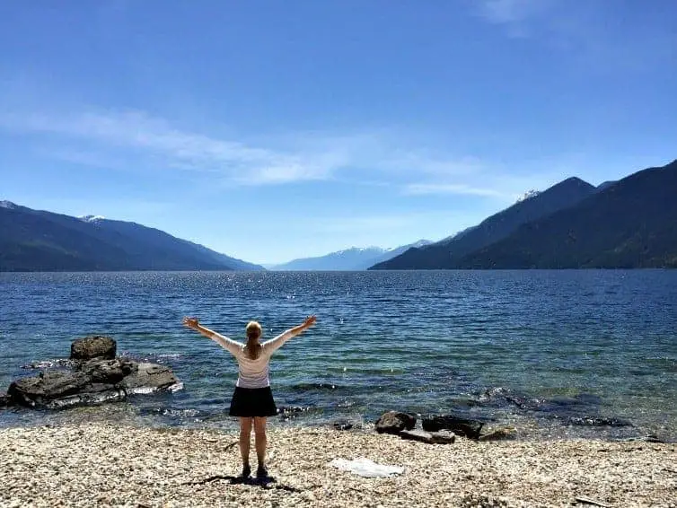 woman on beach in summer at mountain trek retreat in bc