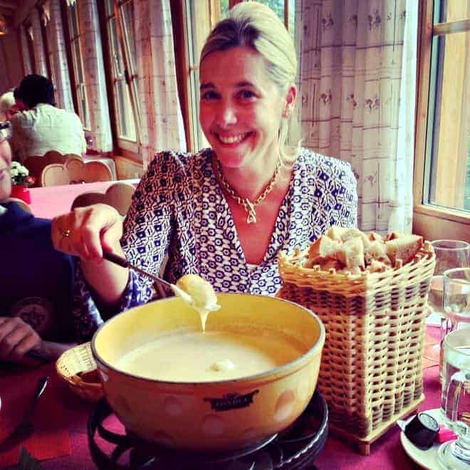 lady enjoying cheese fondue in adelboden