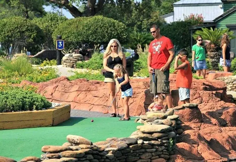 family playing mini golf in myrtle beach