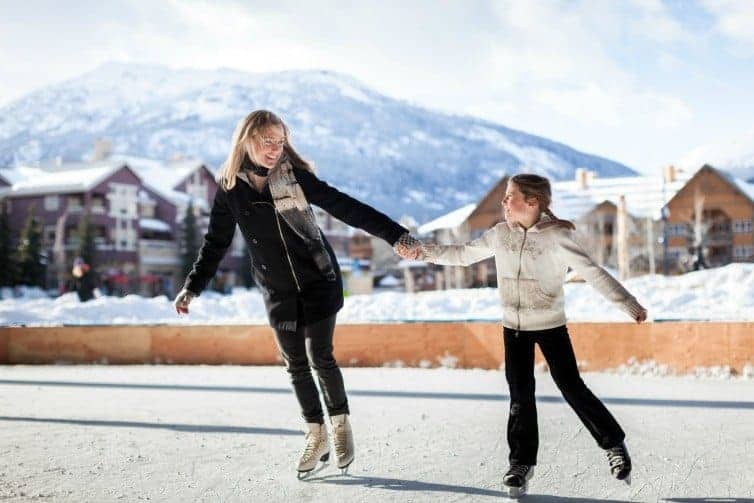 mom and daughter ice skating in whistler