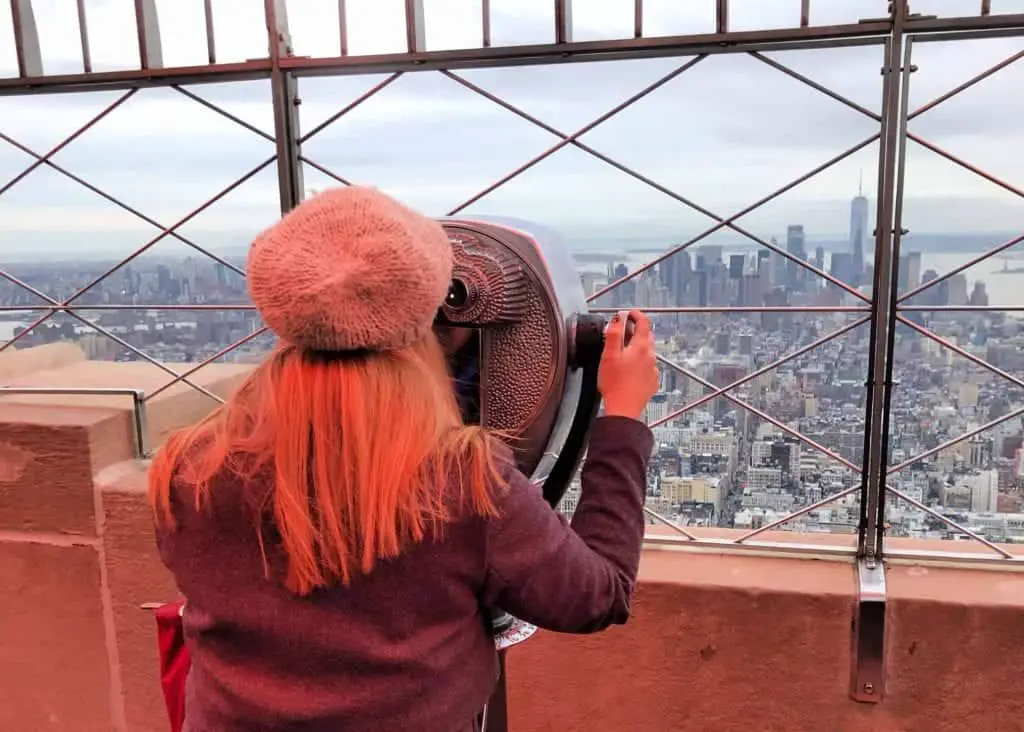 lady looking out from the empire state building 