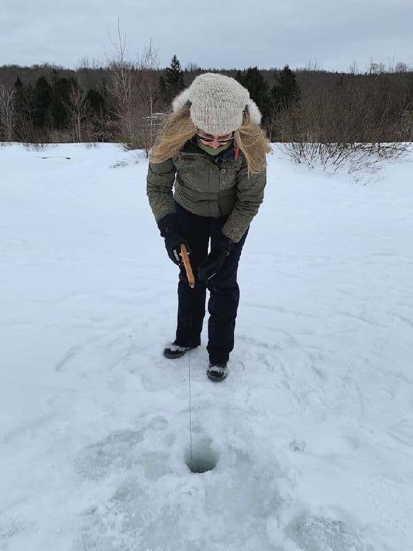 woman ice fishing in quebec