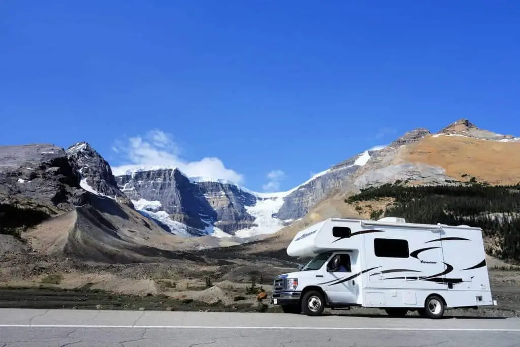 rv on highway in bc with mountains