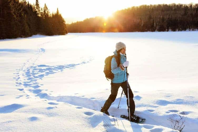 lady snowshoeing in quebec in winter