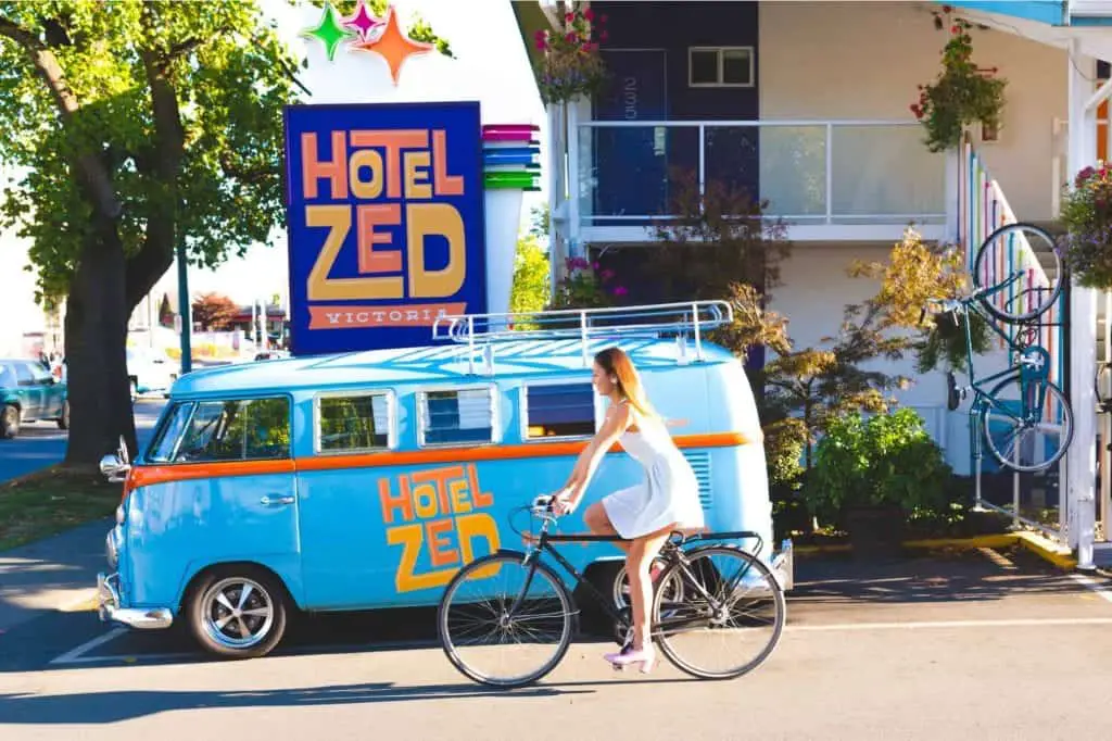 girl on bicycle in front of hotel zed