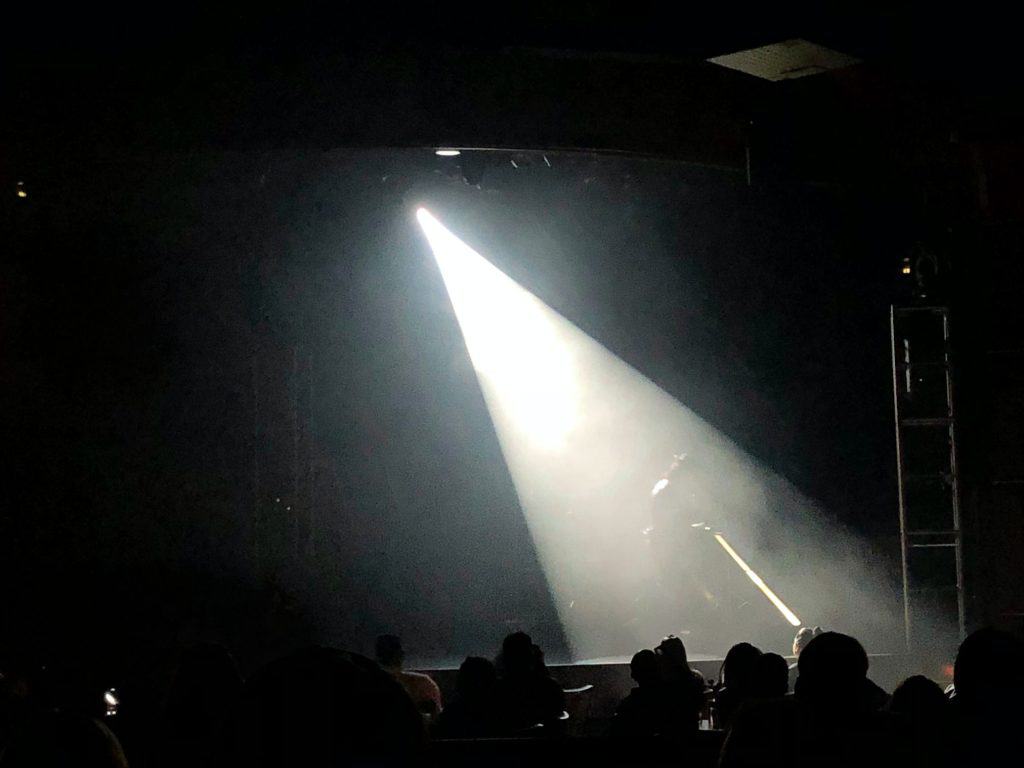 performer illuminated by light