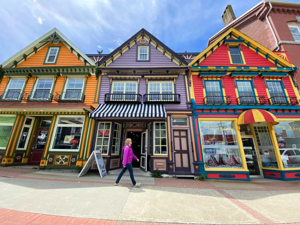lady walking in front of colorful houses