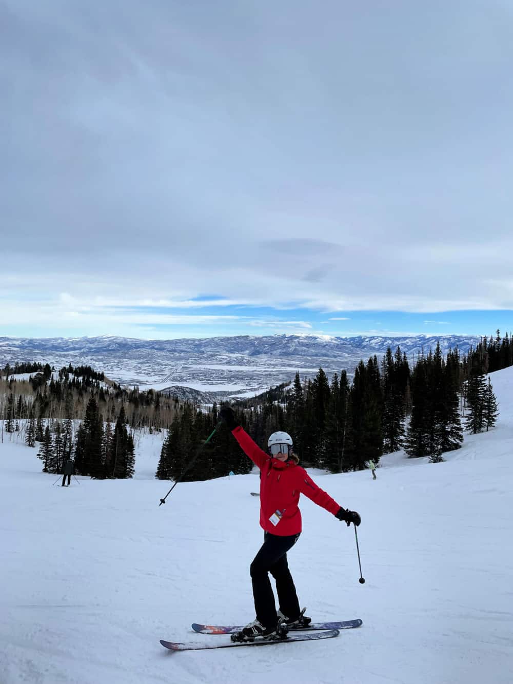 lady in red jacket skiing in utah 