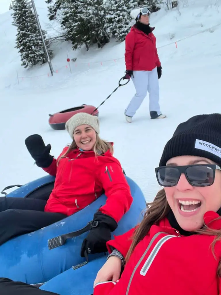 two ladies in red in snow tube