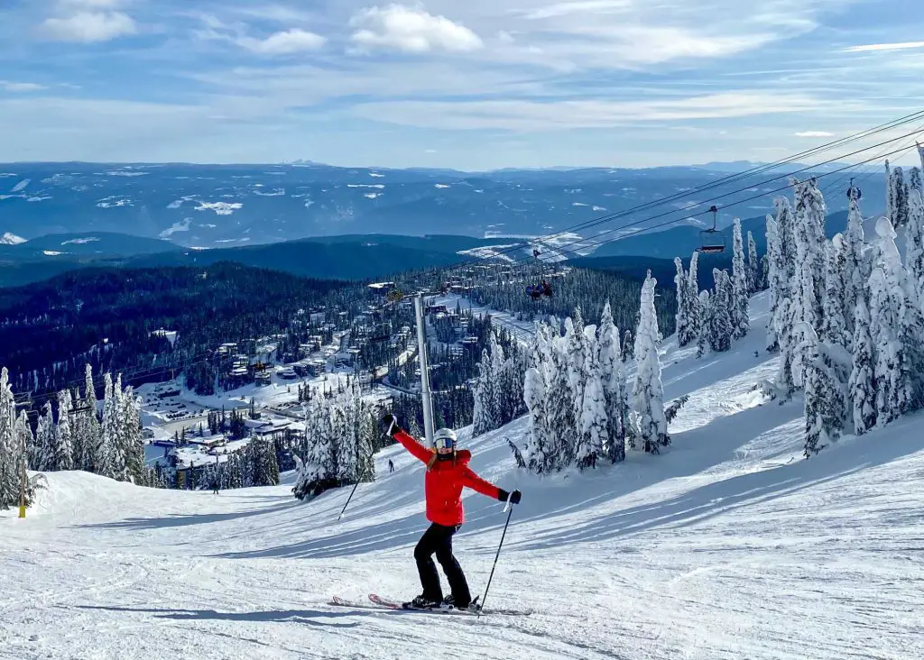 lady in red coat skiing at silverstar in winter