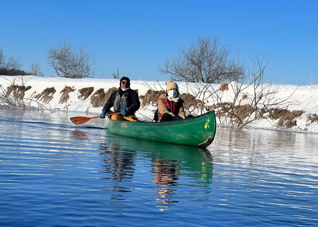 two people canoes on kushiro river in winter