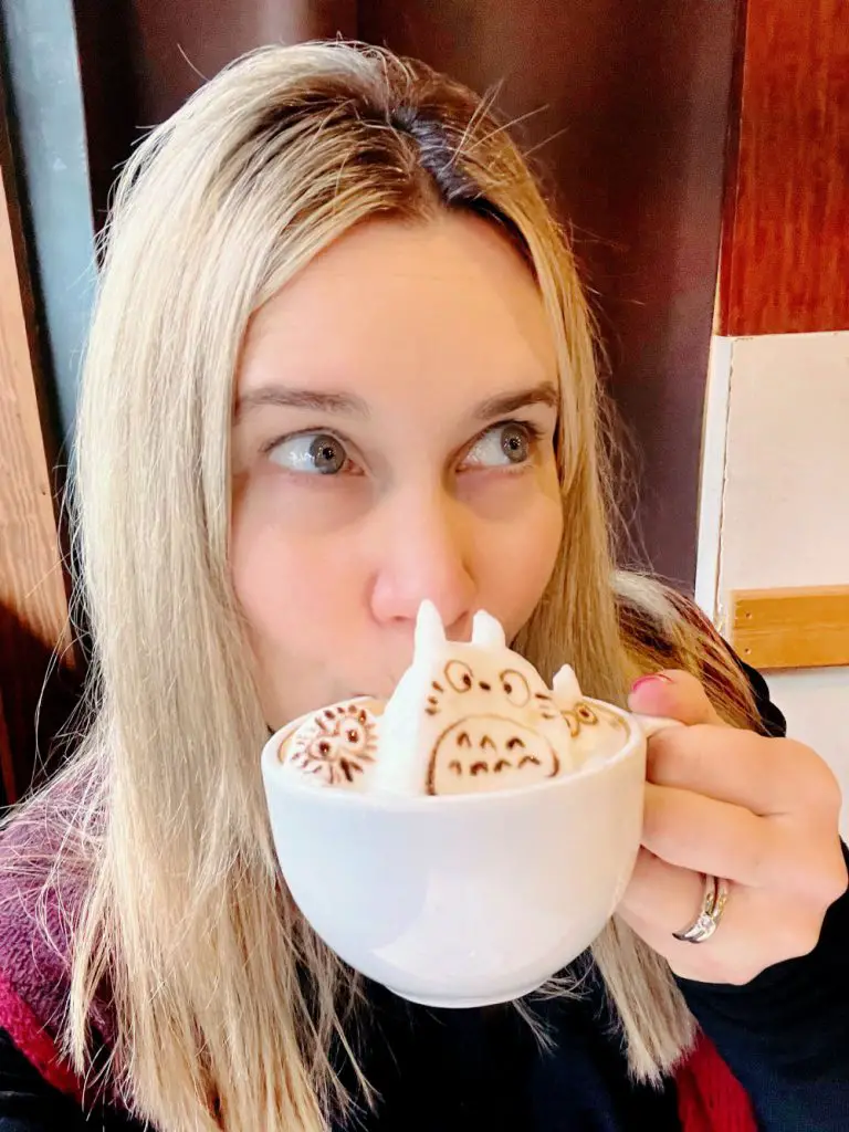 woman drinking 3D latte art of totoro