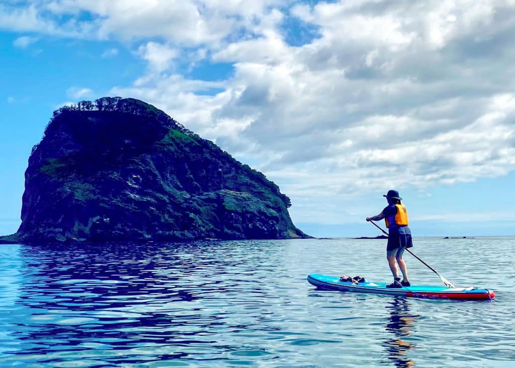lady paddle boarding on sea of japan