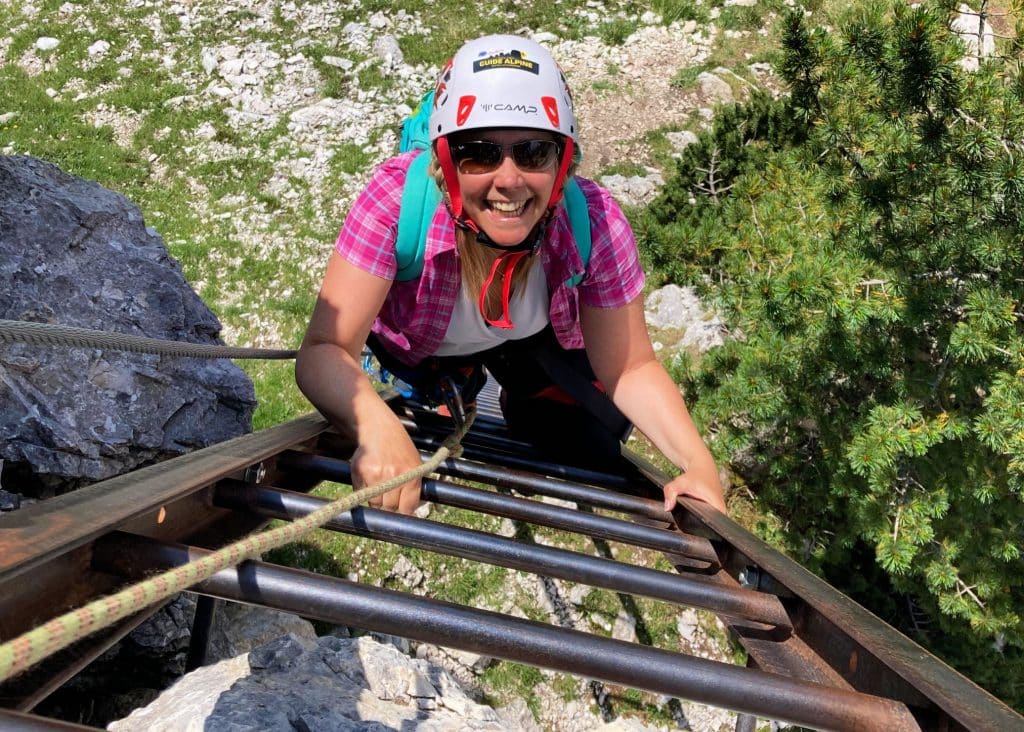 lady in pink on via ferrata route ladder