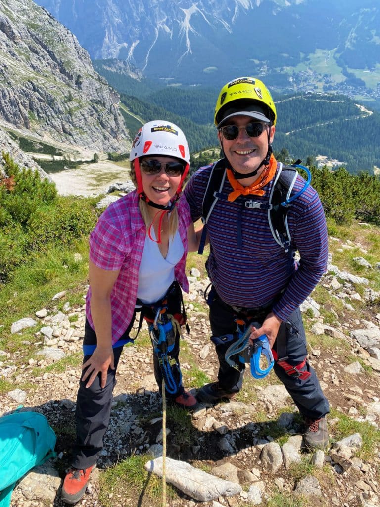 happy couple completing the via ferrata route in the dolomites