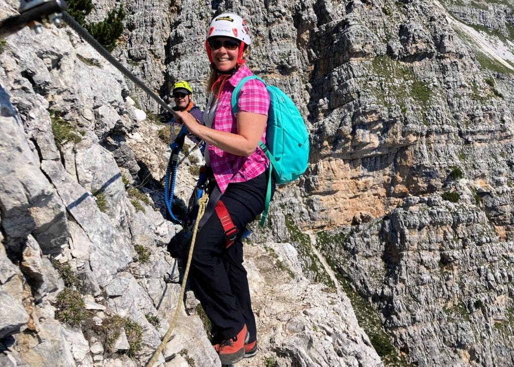 lady in pink climbing via ferrata