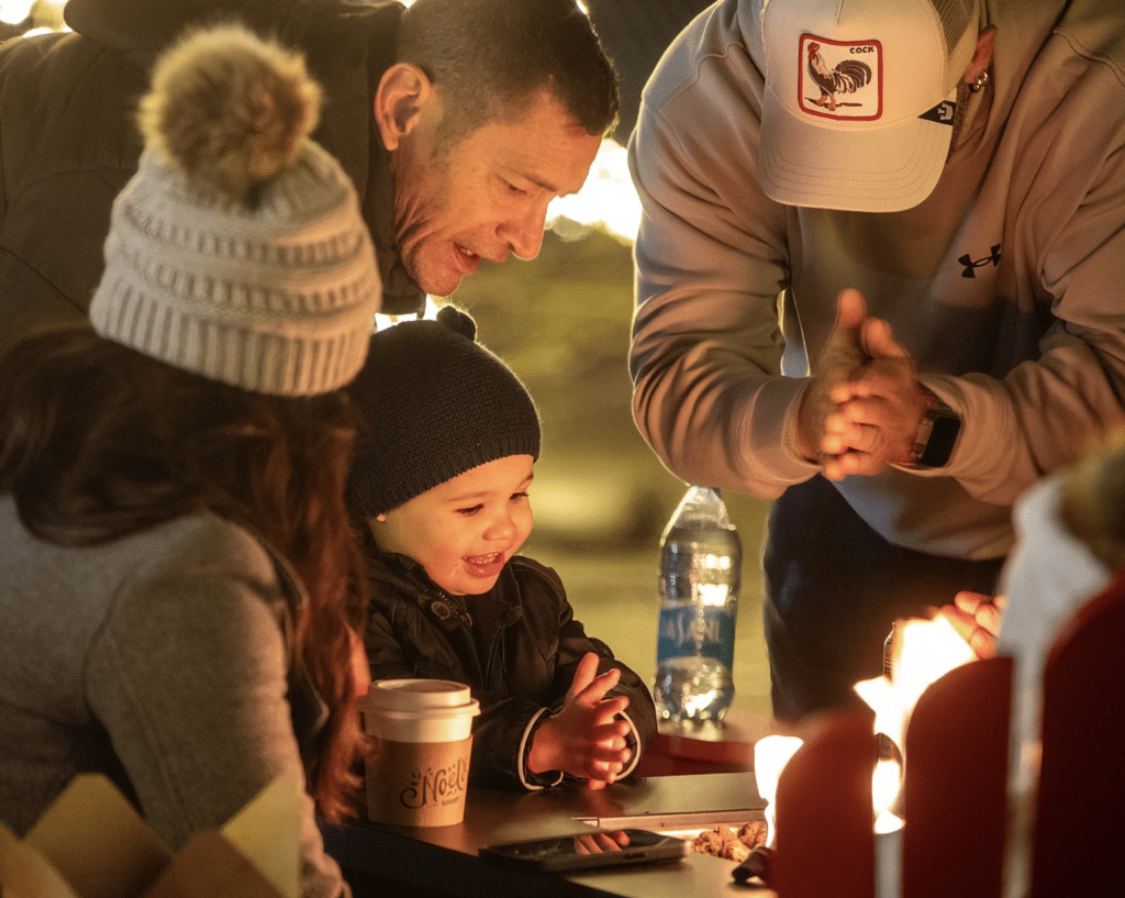 Families enjoying hot chocolate at Noel Surrey and Bright Nights