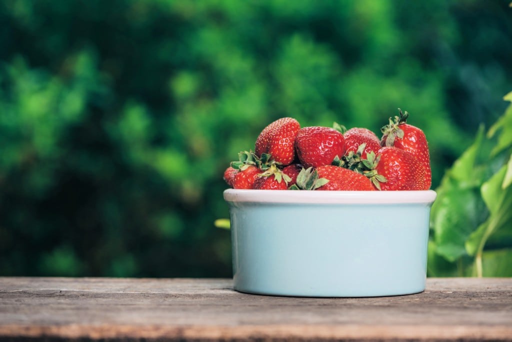 strawberries in a bowl in summer